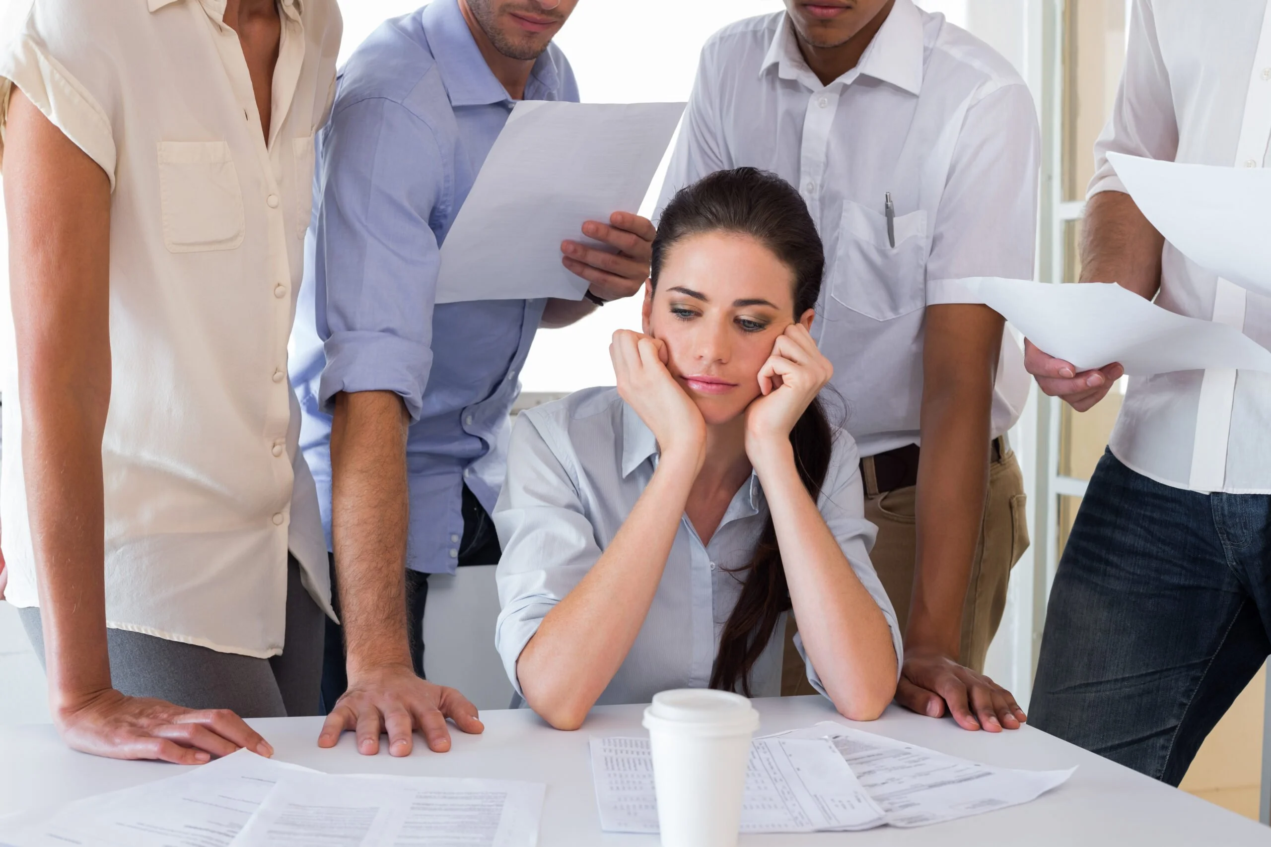 A young woman is surrounded by men | Source: Shutterstock